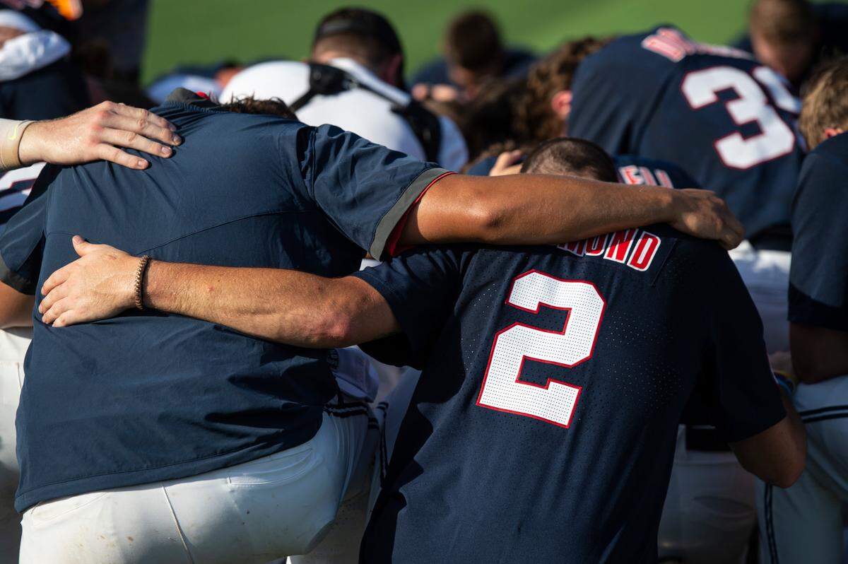 The Ole Miss Rebels pray after winning a shot at the College World Series during the Super Regionals Final at Pete Taylor Park in Hattiesburg on Sunday, June 12, 2022.