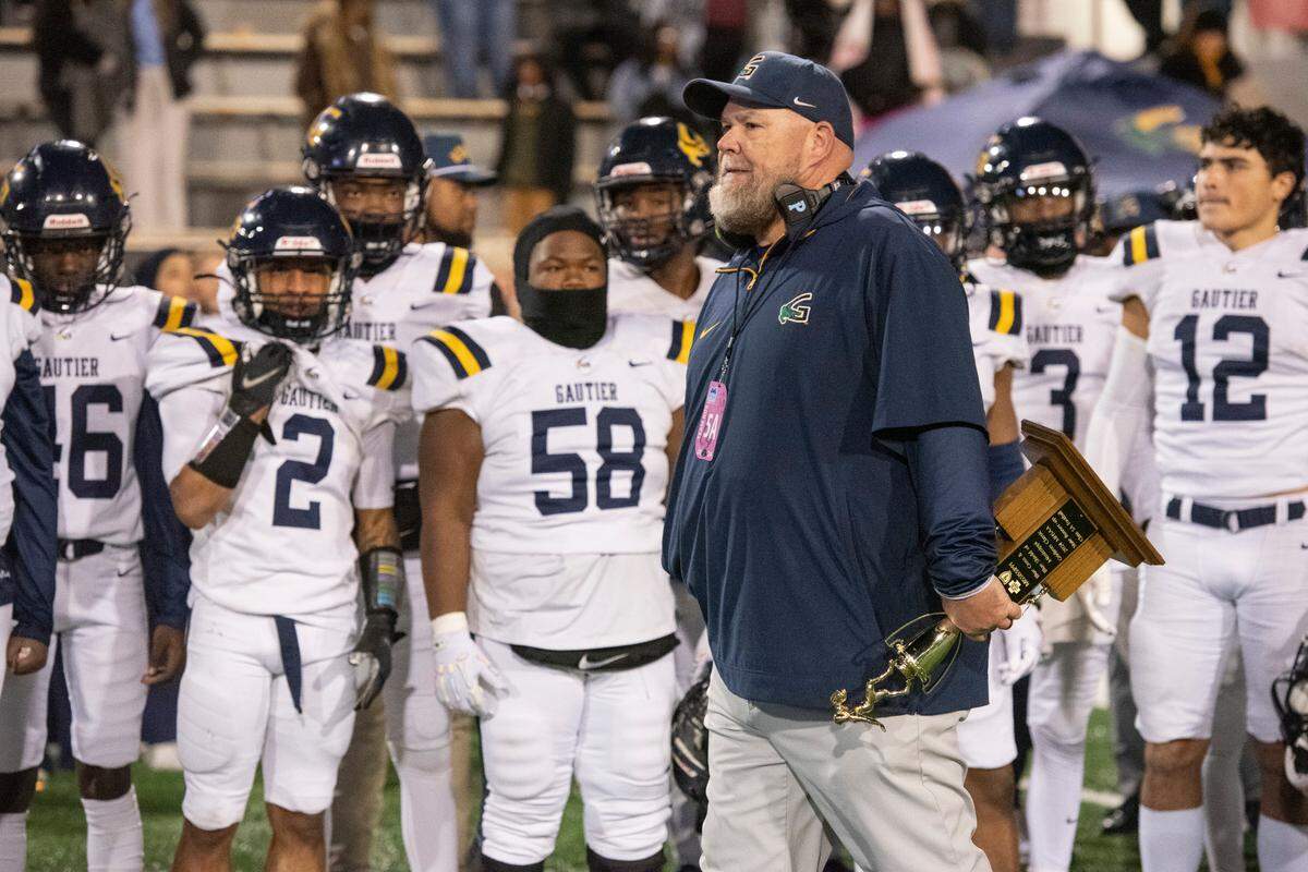 Gautier Head Coach Marc High holds the runner up trophy after Gautier lost the MSHAA Class 5A Football Championship at M.M. Roberts Stadium in Hattiesburg on Friday, Dec. 6, 2024.