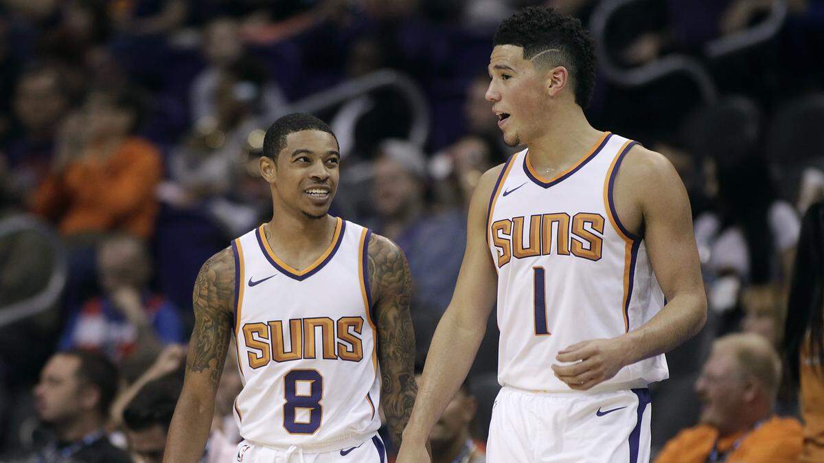 Phoenix Suns’ Tyler Ulis (8) and Devin Booker talk as they walk back on to the court following a timeout during an exhibition game on Oct. 13, 2017, in Phoenix.