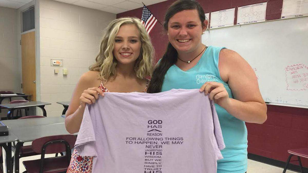 Pass Christian High School senior Allison Hennessey shows the t-shirt that her friend Jettie Necaise designed for her.