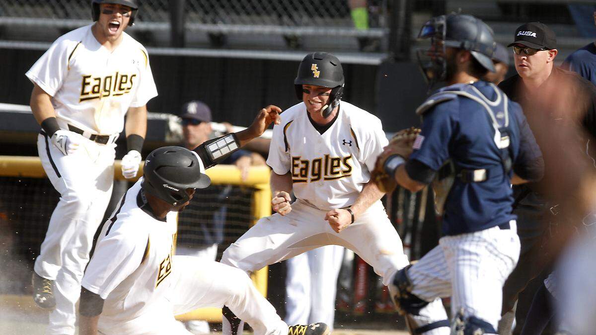 TIM ISBELL/SUN HERALDSouthern Miss teammates react as catcher Chuckie Robinson scores against Rice, Saturday, Apr. 23, 2016. 