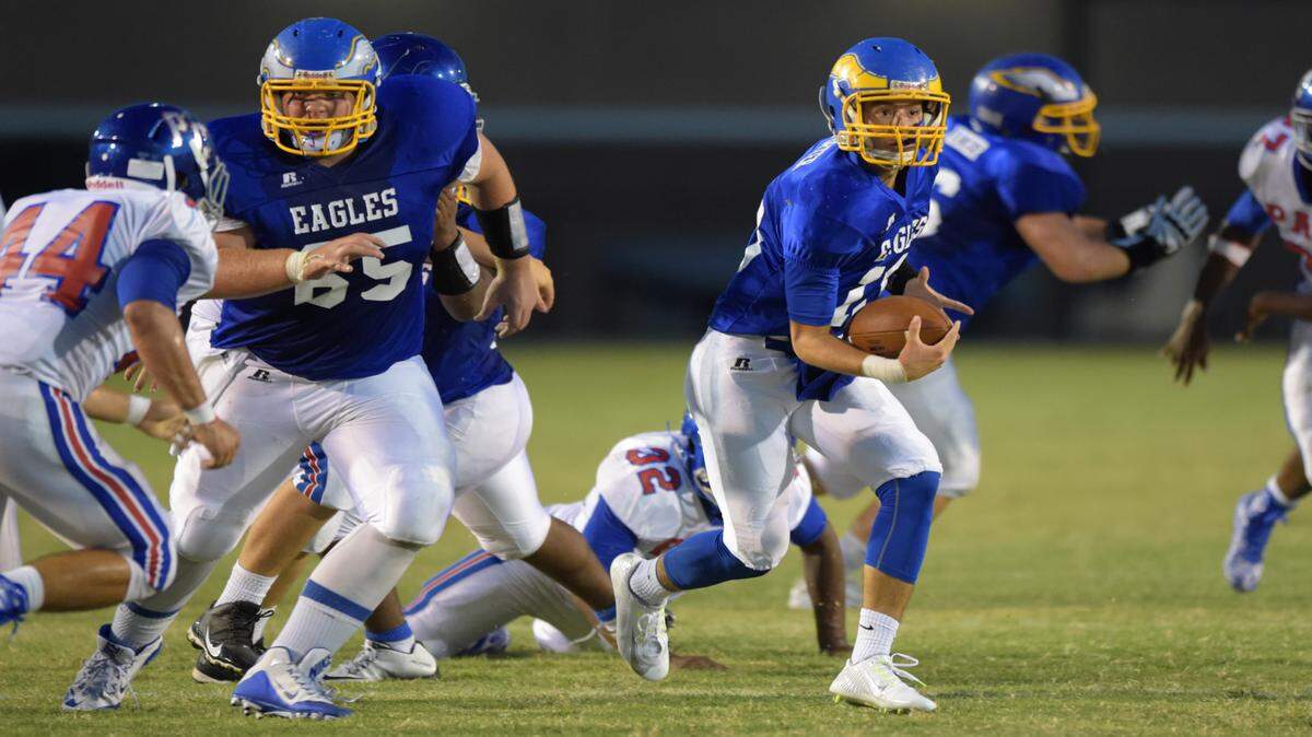 GLENN ANDREWS/SPECIAL TO THE SUN HERALD 
 Resurrection Catholic quarterback Blake Porter (10) keeps the ball and scrambles against Pass Christian.