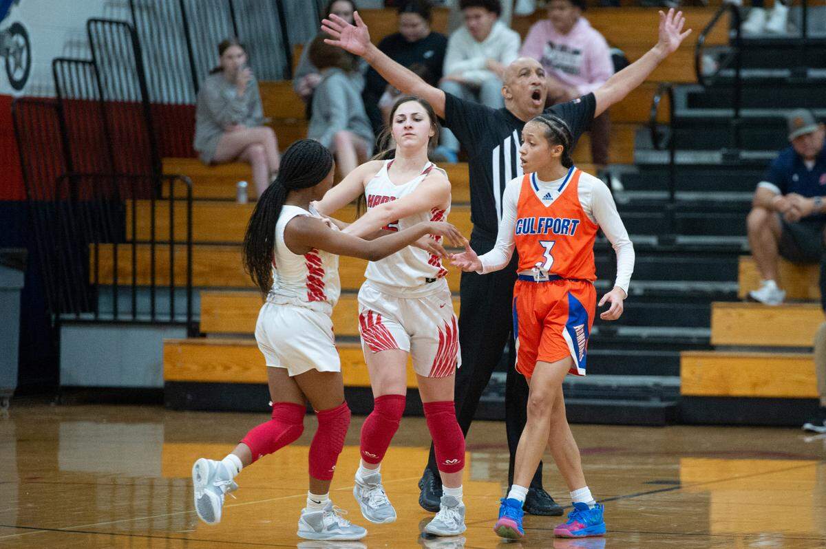 Hancock’s Cambria Necaise separates her teammate LaKeitha Sampson from Gulfport’s Madison O’Dell as tensions rise between the two players during a close game between Gulfport and Hancock at Hancock High School in Kiln on Tuesday, Jan. 10, 2023.