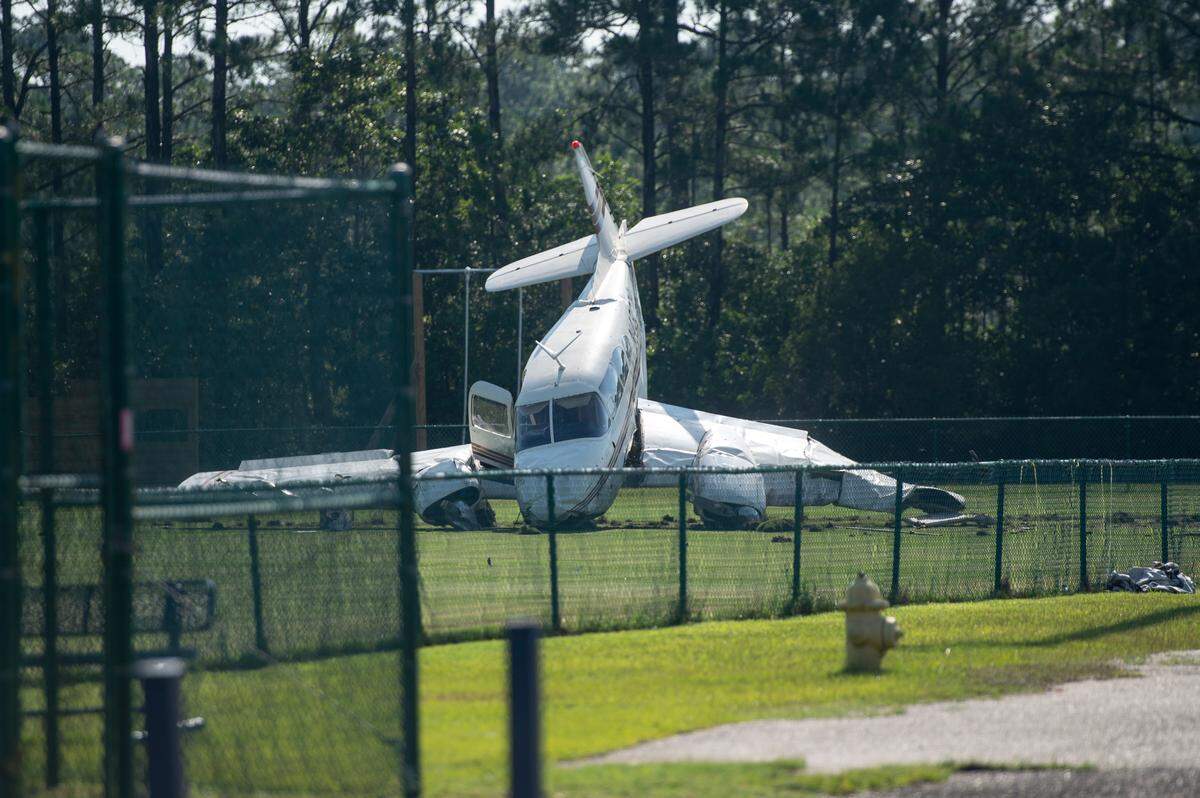 A small plane sits in a field behind the Ocean Springs Middle School in Ocean Springs on Friday, June 23, 2023, after crashing upon takeoff from the Ocean Springs Airport.