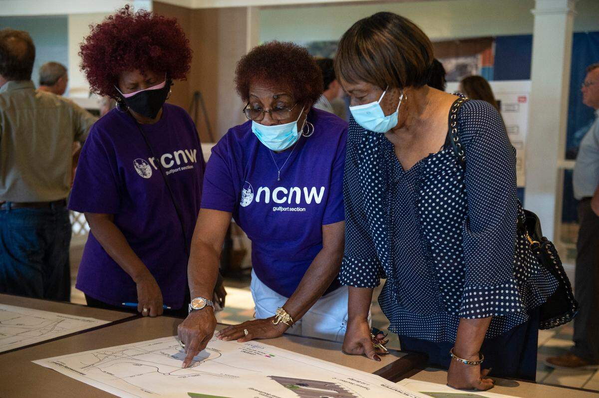 Members of the Gulfport section of the National Council of Negro Women look over plans for a potential road project extending several roads west of Highway 49 during a public hearing on the project at Gulfport Premium Outlets in Gulfport on Wednesday, July 13, 2022. The project has faced criticism for potentially having a negative environmental impact and potentially causing more flooding in the predominately African-American neighborhood of Forrest Heights.