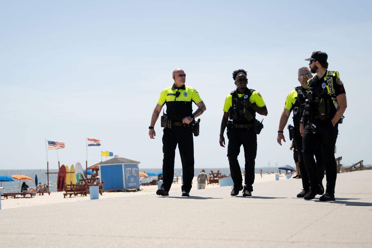 Police officers patrol Biloxi Beach on Saturday during Black Spring Break.