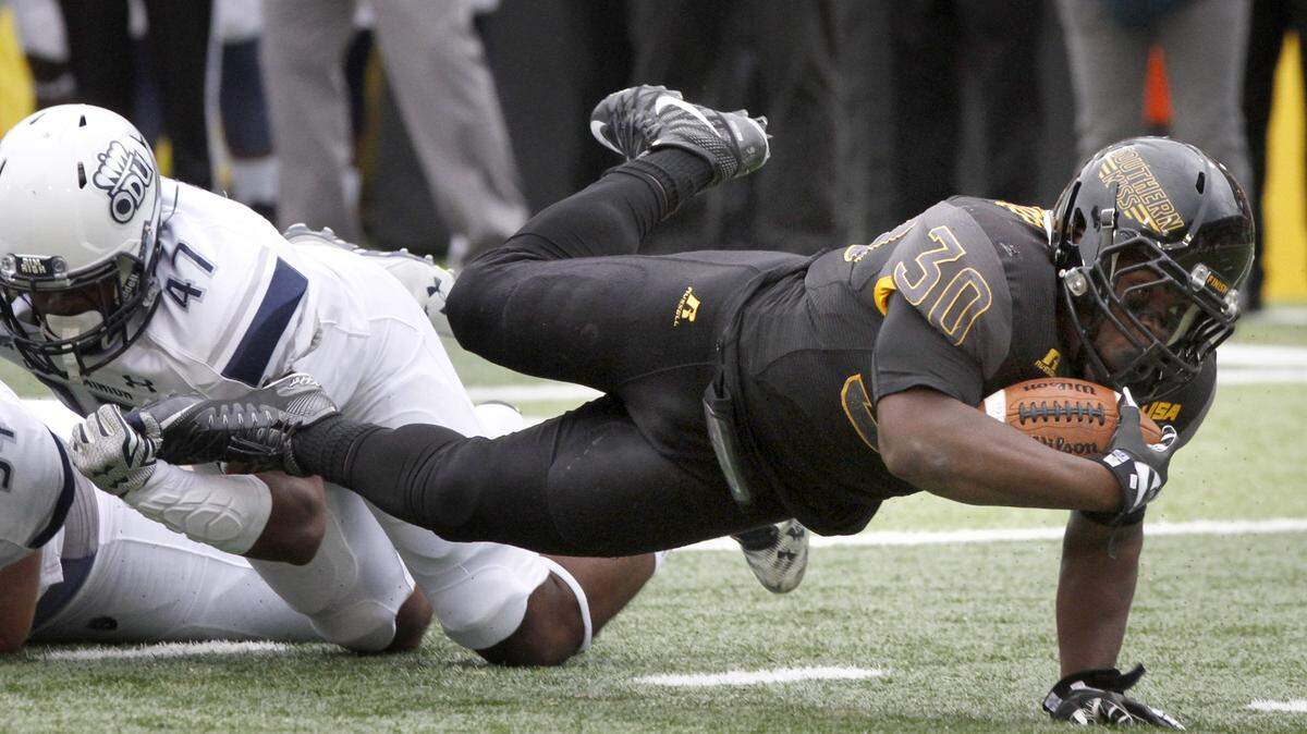 TIM ISBELL/SUN HERALDSouthern Miss running back Jalen Richard dives for extra yards as his is brought down by Old Dominion's T. J. Ricks, Saturday, Nov. 21, 2015. 