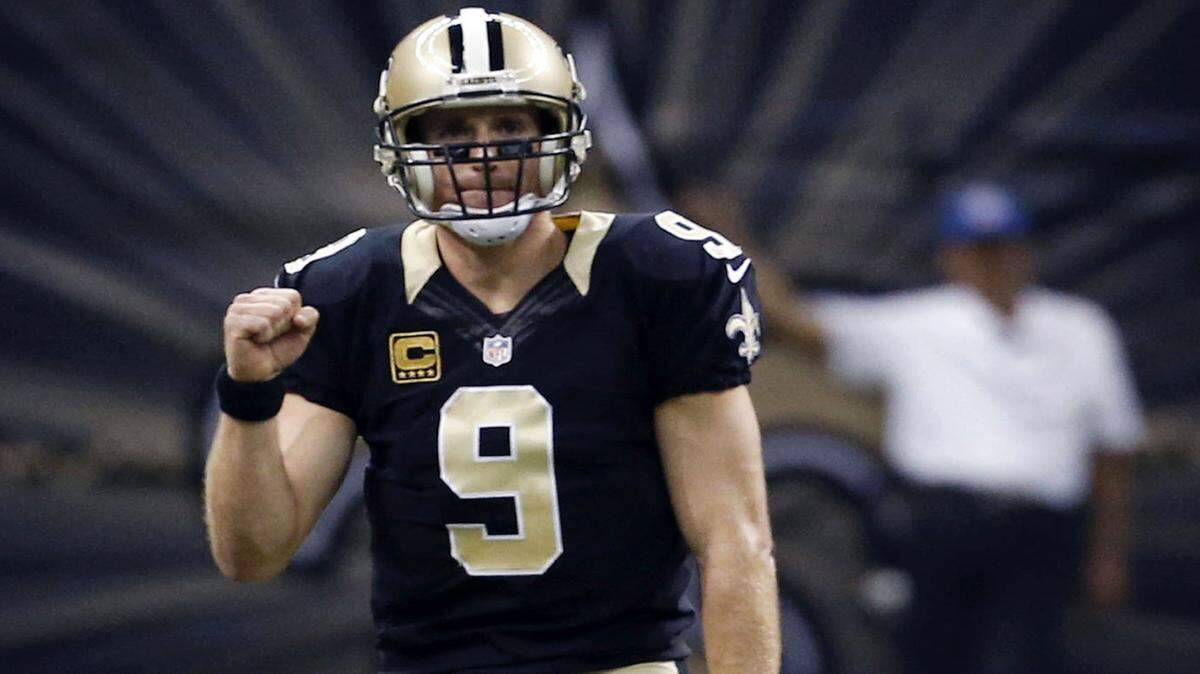 New Orleans Saints quarterback Drew Brees (9) reacts after throwing a touchdown pass to wide receiver Brandin Cooks in the first half of an NFL football game against the Jacksonville Jaguars in New Orleans, Sunday, Dec. 27, 2015. (AP Photo/Jonathan Bachman)