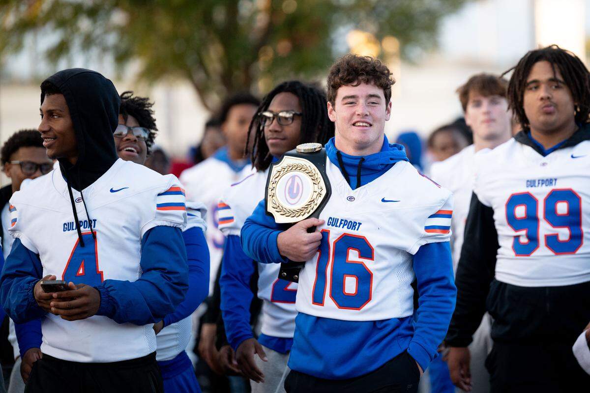 Gulfport players walk down 22nd Avenue during the Champions Christmas Parade in Gulfport on Monday, Dec. 8, 2025.