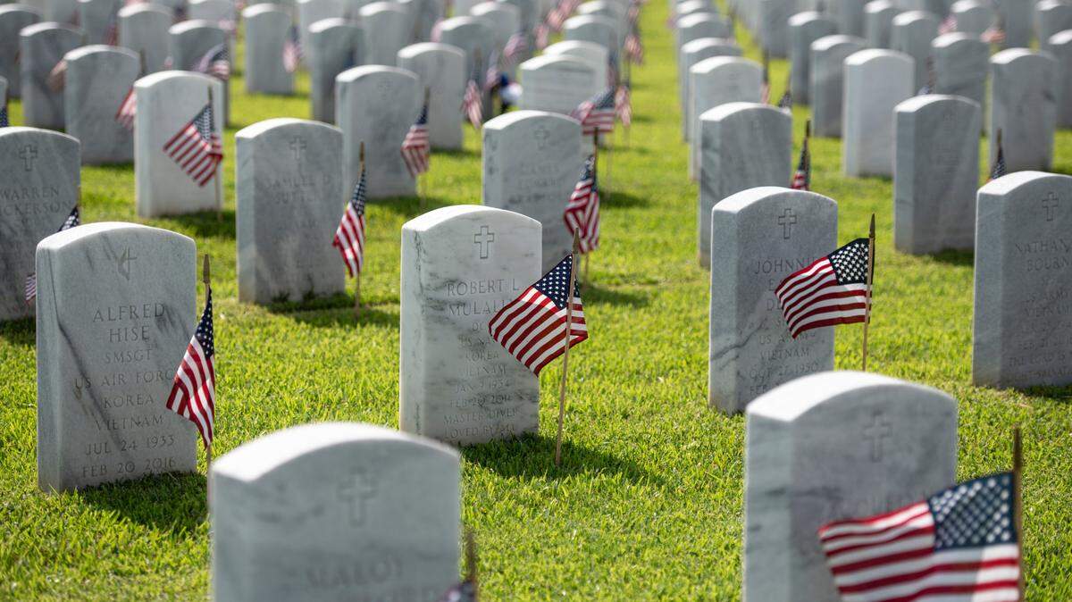 Thousands of tiny American flags decorate the graves of American service members at Biloxi National Cemetery in Biloxi ahead of Memorial Day on Saturday, May 25, 2024.