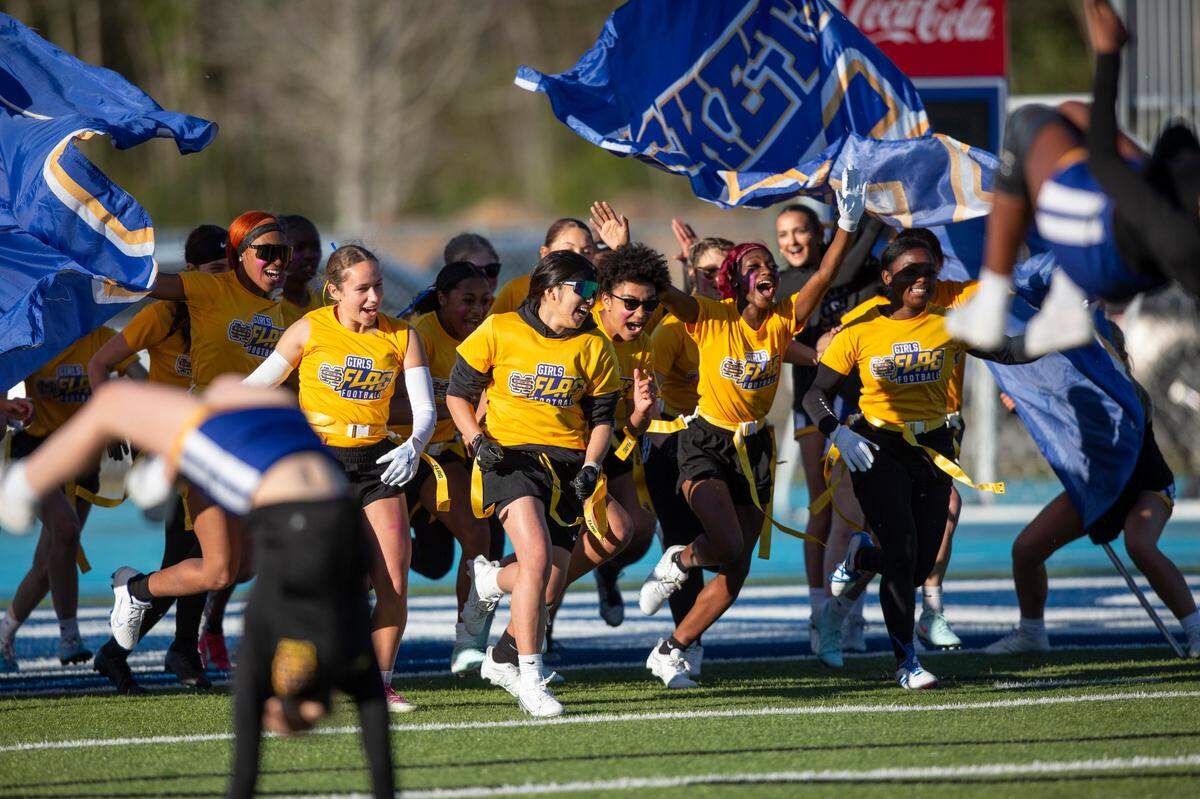 The St. Martin Flag Football Team runs onto the field for a Jamboree game at Vancleave on Thursday, March 20, 2025.