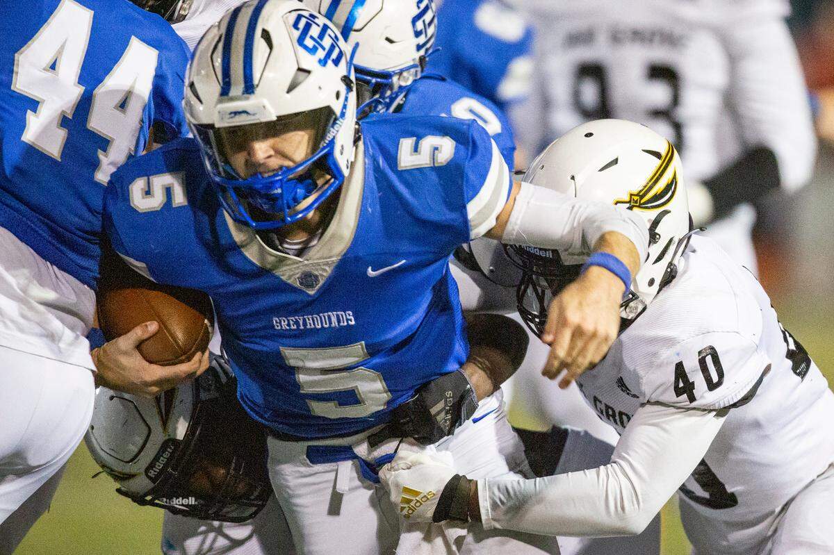 Ocean Springs’ quarterback Bray Hubbard gets tackled by Oak Grove during a 6A playoff game at Greyhound Stadium in Ocean Springs on Friday, Nov. 18, 2022.