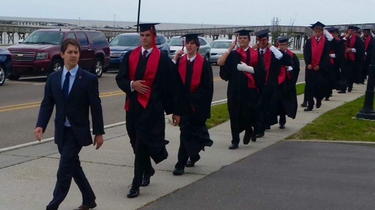 MAURICE SINGLETON/SPECIAL TO THE SUN HERALD 
 Principal Patrick McGrath leads the march of 2016 St. Stanislaus College graduates from campus along Beach Boulevard to Our Lady of the Gulf Catholic Church in Bay St. Louis on Saturday, May 28, 2016.