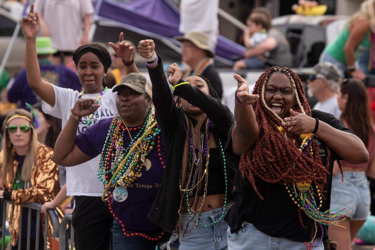 A crowd dances to a DJ’s music during the Gulf Coast Carnival Association Mardi Gras parade in Biloxi on Tuesday, Feb. 21, 2023.