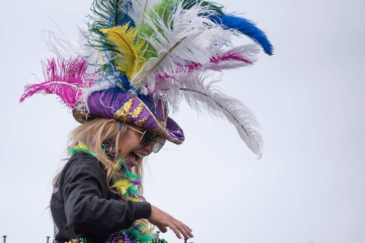 A float rider throws beads to the crowd during the Gulf Coast Carnival Association Mardi Gras parade in Biloxi on Tuesday, March 4, 2025.