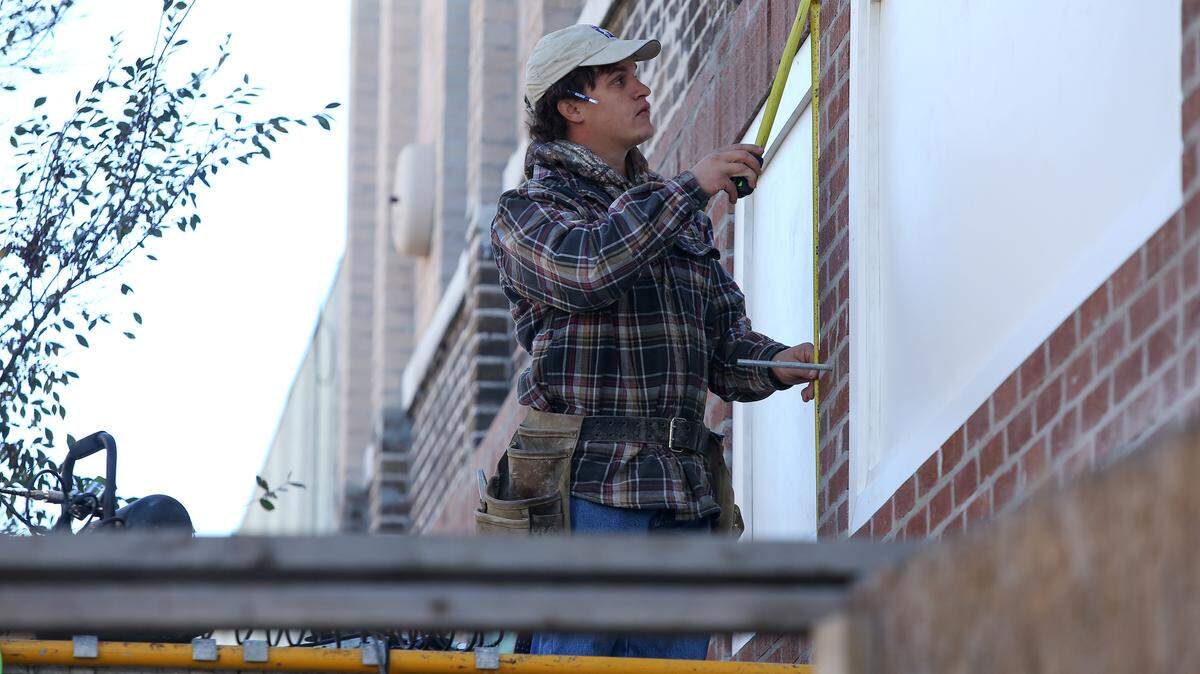 AMANDA McCOY/SUN HERALD 
 Weldon Guttierrez of Starks Contracting Co. Inc. works in downtown Gulfport on Monday, Nov. 23, 2015. Temperatures were in the low 40s Monday morning. Guttierrez said he stays warm by wearing three layers.