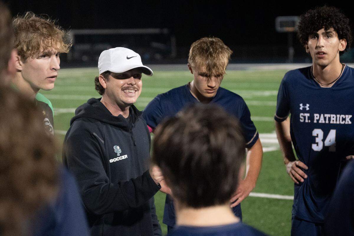 St. Patrick head coach Ryan Worsham speaks with his players as they prepare for overtime during a soccer game at St. Patrick Catholic High School on Tuesday, Feb. 17, 2026