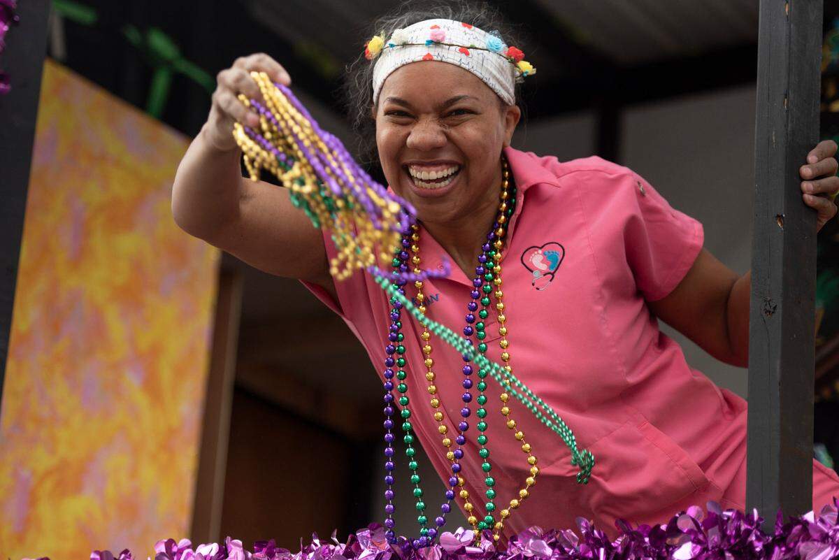 A float rider throws beads to the crowd during the Gulf Coast Carnival Association Mardi Gras parade in Biloxi on Tuesday, March 4, 2025.
