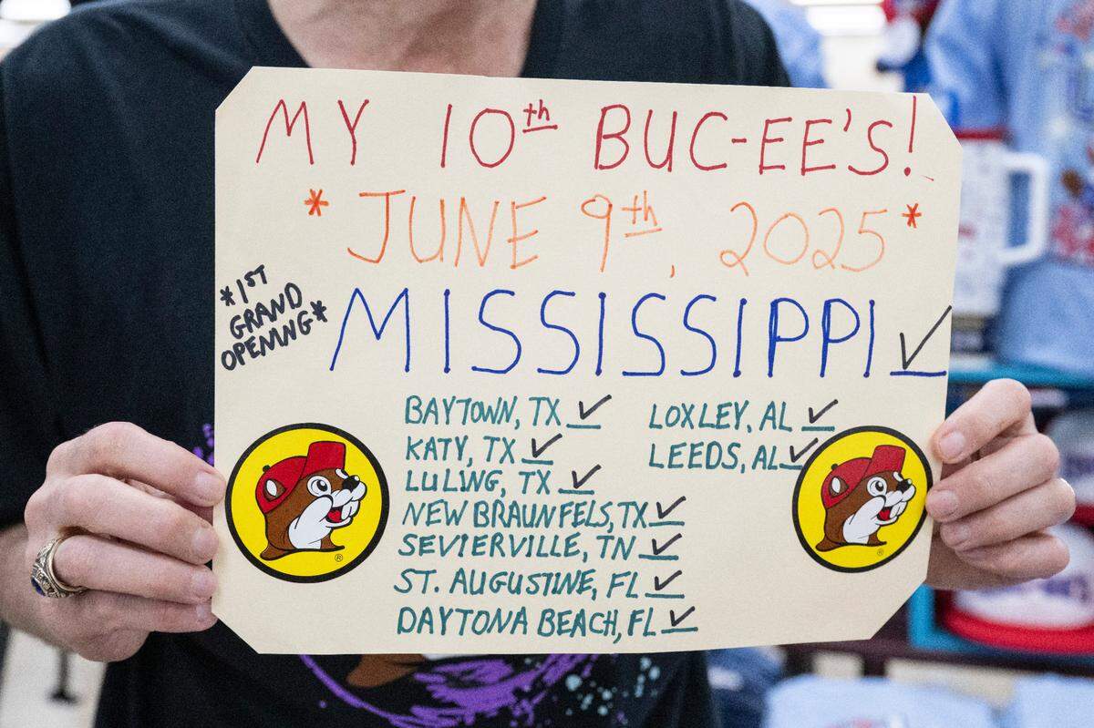 Michael Foy of Pearl River, LA, holds up a sign documenting all the Buc-ee’s he has been to as he arrives at the brand new Buc-ee’s in Harrison County, MS, on Monday, June 9, 2025.