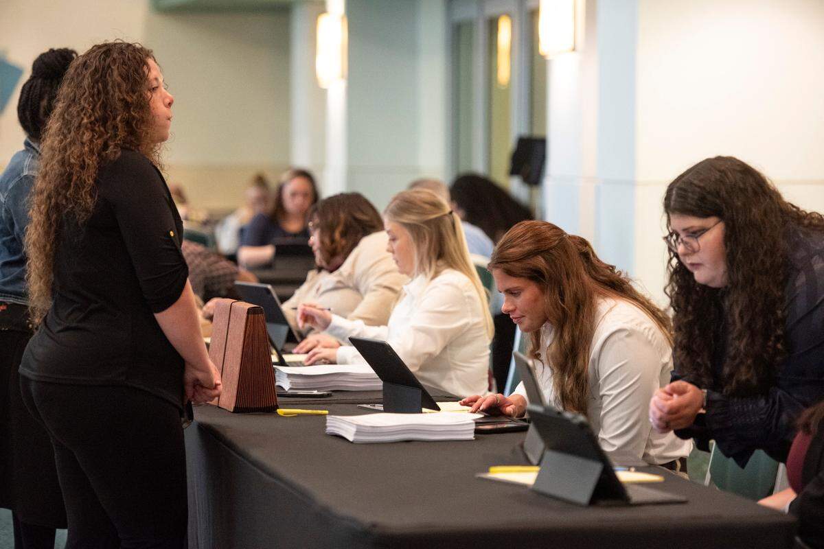 Buc-ee’s hiring staff check in potential job applicants during a hiring fair for the Texas-based gas station chain at the Mississippi Coast Coliseum on Wednesday, April 2, 2025.
