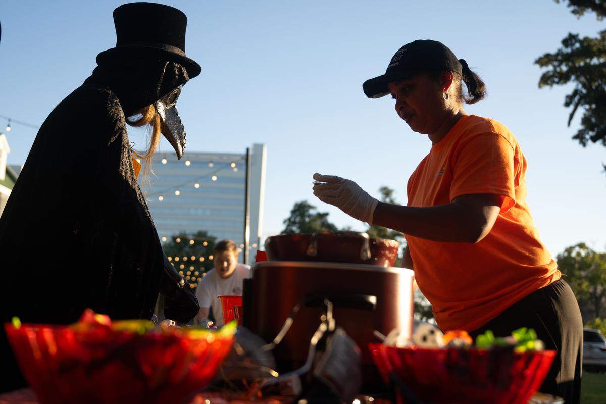 Freida Ray, right, serves chili during Boo On The Rue in Biloxi on Thursday, October 30, 2025.