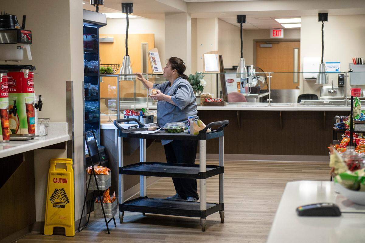 A cafeteria worker restocks for lunch at the George Regional Health System’s hospital in Lucedale, Mississippi. The cafeteria was expanded with $1 million from the state.