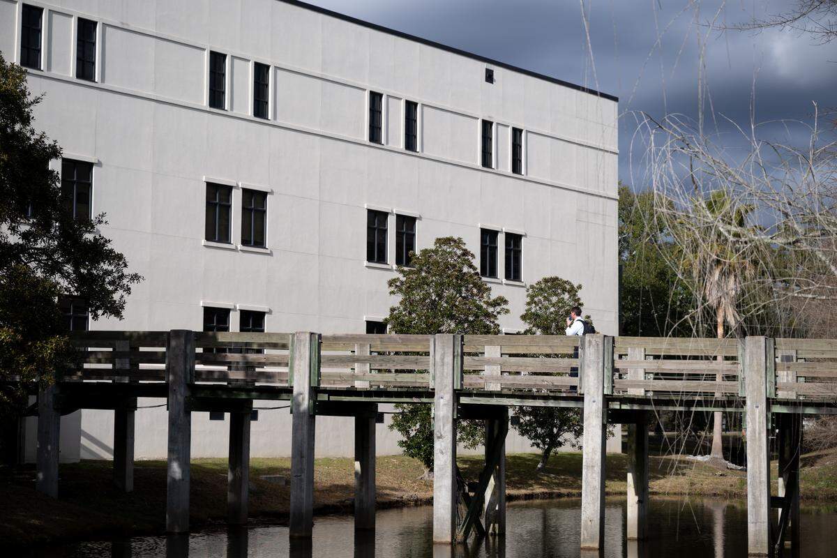 A man walks across a footbridge at The University of Southern Mississippi Gulf Park Campus on Tuesday, Feb. 3, 2026.