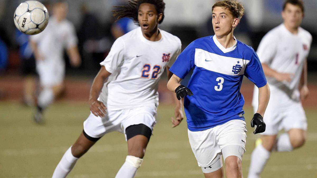 CHRIS TODD\SPECIAL TO THE SUN HERALD 
 Ocean Springsí P.J. Irwin (3) competes against Madison Central's Devin Brown (22) for a loose ball on Saturday, February 7, 2015, at the MHSAA state soccer championships at Clinton High School in Clinton, Miss. The Greyhounds meet Madison central for the 6A state title on Saturday.