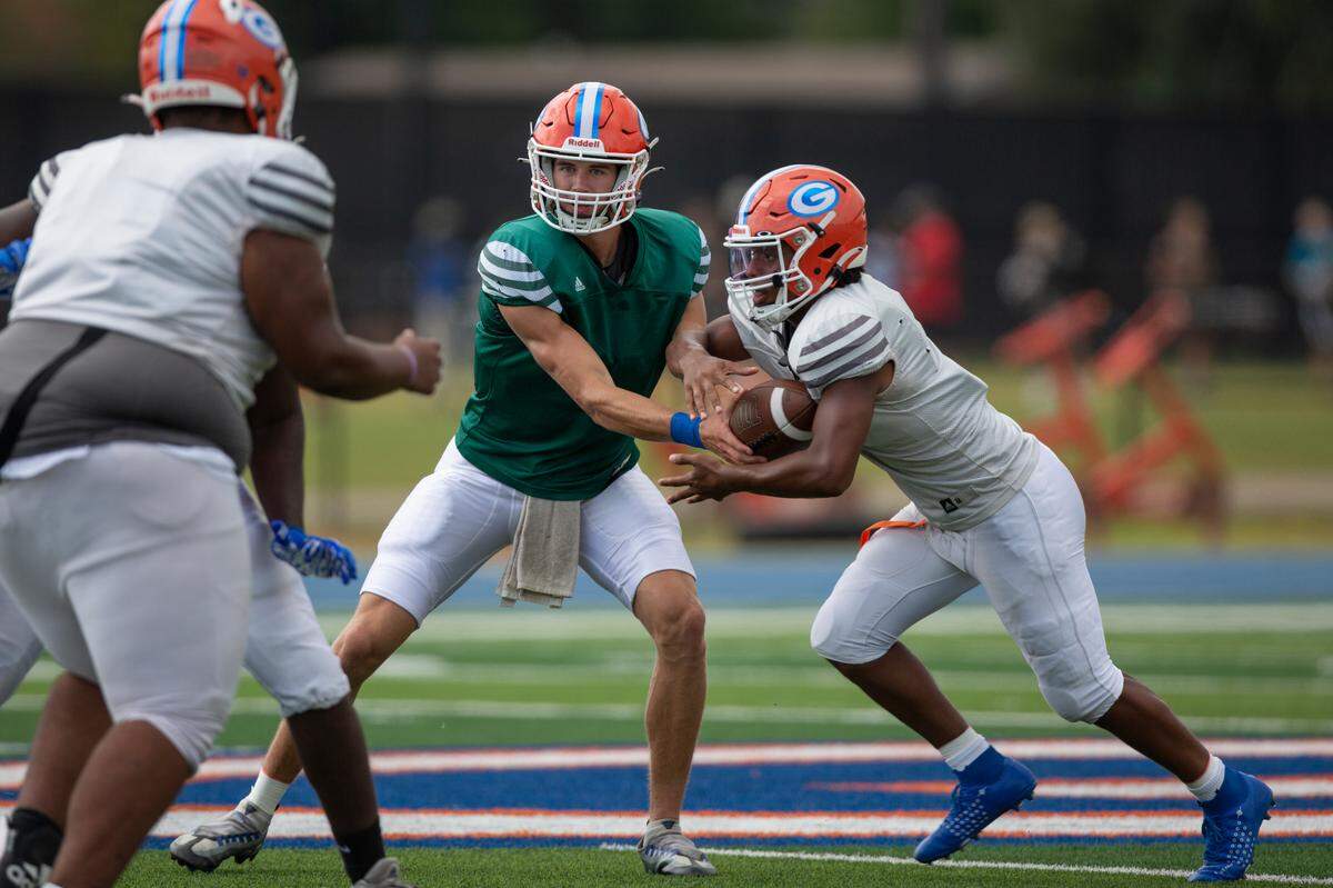 Gulfport Admirals quarterback Nico Williams hands the ball off to a teammate during practice at Gulfport High School in Gulfport on Tuesday, Aug. 29, 2023.