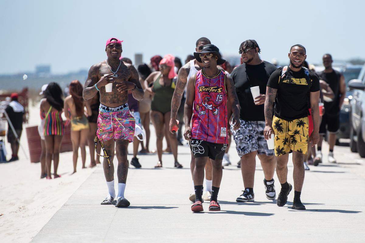 Spring breakers enjoy the weather at Biloxi Beach during Black Spring Break in Biloxi on Saturday, April 13.