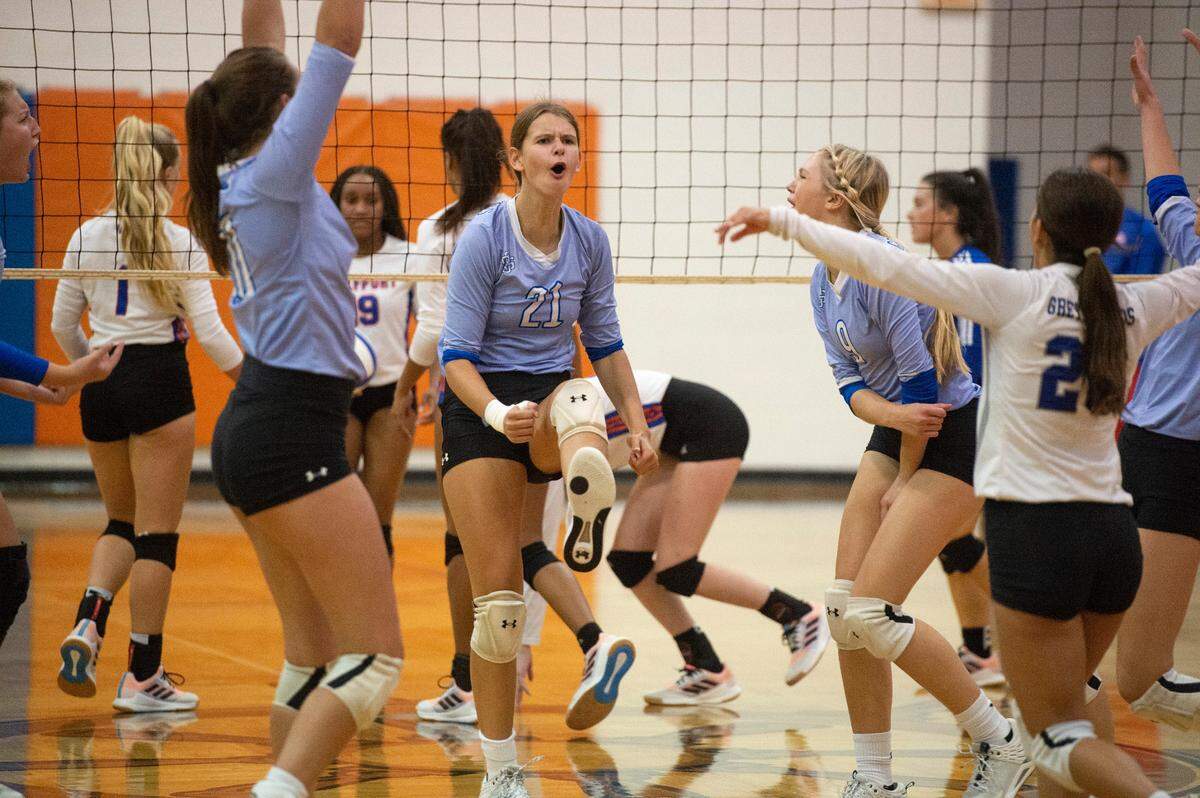 Ocean Springs’ Anna Hoffmayer (#21) celebrates with her teammates after a point during a game against Gulfport at Gulfport High School in Gulfport on Tuesday, Oct. 4, 2022.