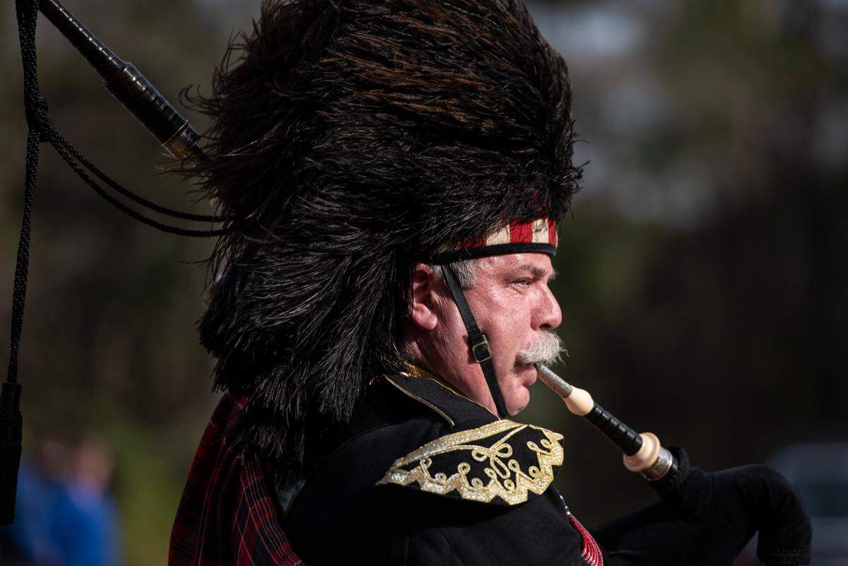 Bagpipers play during a graveside service for George County Sheriff’s Deputy Jeremy Malone at Tanners Cemetery in George County on Friday, Jan. 12, 2024.