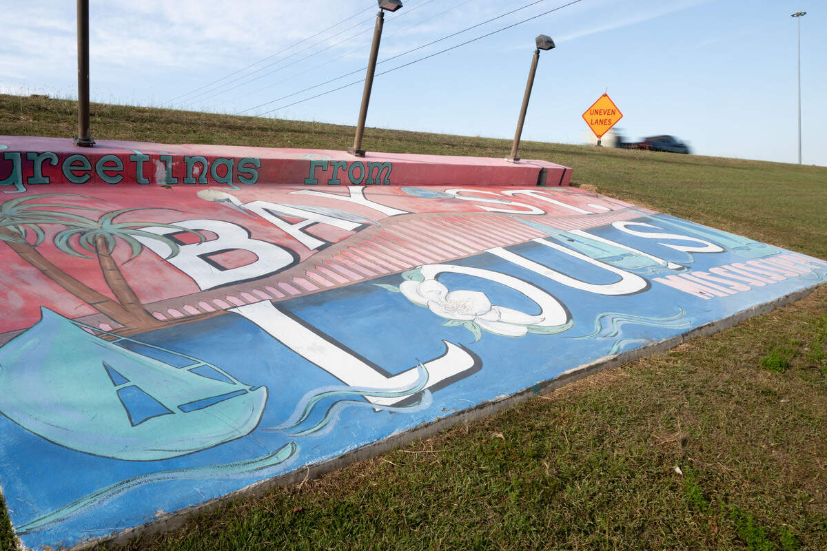 A mural outside Bay St. Louis on Wednesday, Sept. 17, 2025. The concrete slab was once a monument to Hurricane Katrina that read “KATRINA HIGH WATER 2005.” The message was painted over long ago, but the faint outline of old block letters are still visible beneath the new design.