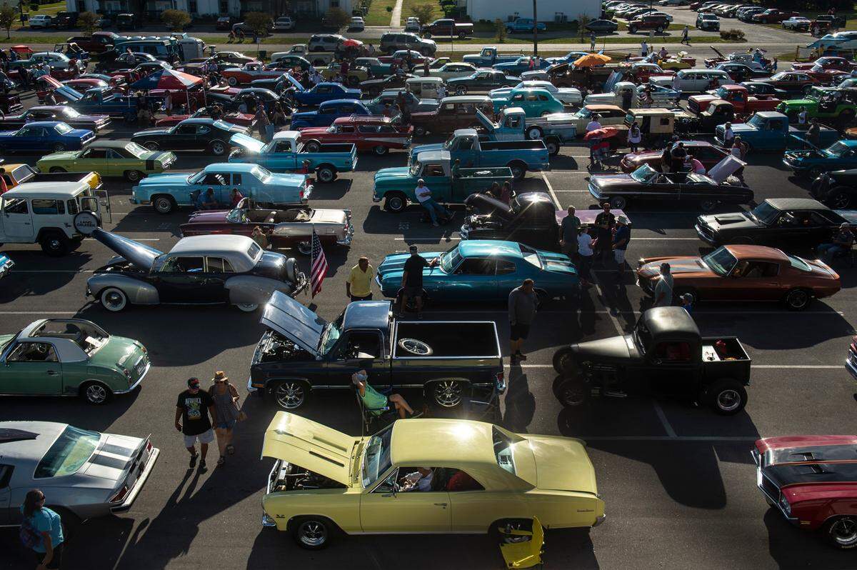 Cars line up at the Long Beach High School parking lot before the Long Beach Parade during Cruisin’ The Coast in Long Beach on Monday, Oct. 3, 2022.