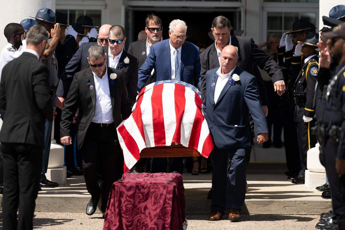 Pallbearers carry out Michael Jimerson’s casket Friday.