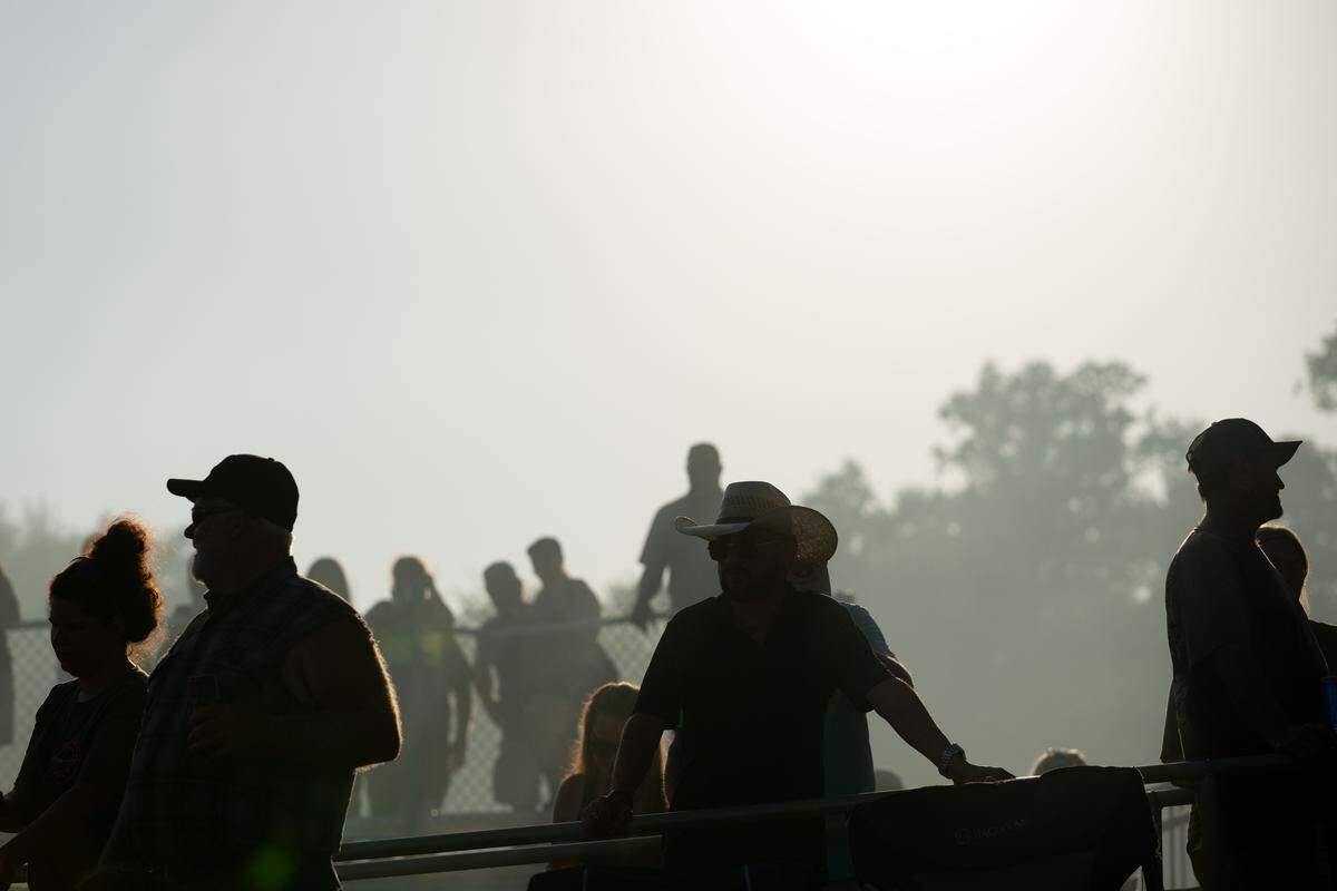 Event attendees watch as cars get set during Burn ‘Em Up In The Pass on Thursday, Oct. 9, 2025.