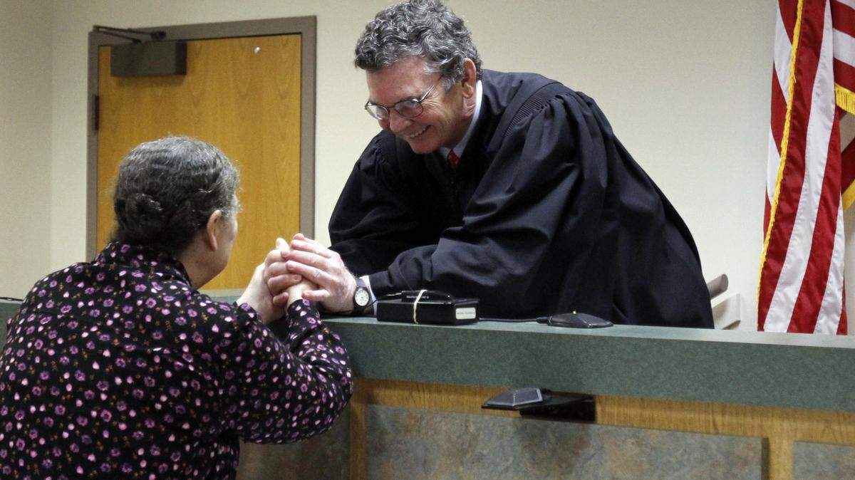 TIM ISBELL/SUN HERALD/2014Judge Neil Harris shares a private word with Patty Bang Williams after a brief ceremony in his courtroom in Pascagoula.
