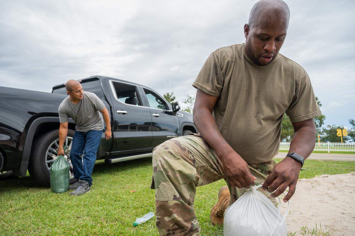 Anthony Woods and Fabian Barreto, who both serve in the Army on the Mississippi Coast, tie sandbags to prepare for heavy rain and storm surge from Hurricane Sally in Gulfport on Monday, Sept. 14, 2020.