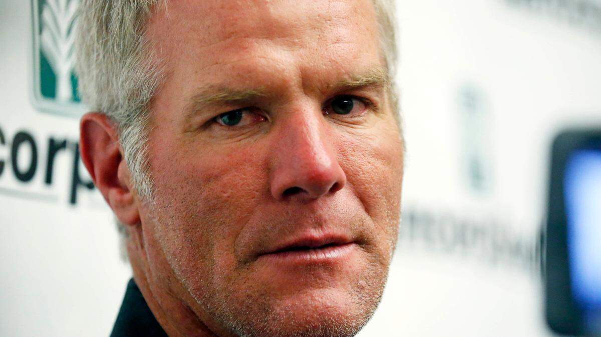 Former NFL football quarterback Brett Favre speaks with reporters prior to his induction to the Mississippi Hall of Fame in Jackson, Miss., on Aug. 1, 2015. Favre is asking to be removed from a civil lawsuit in Mississippi that seeks to recover millions of dollars in misspent welfare money that was intended to help some of the poorest people in the U.S. (AP Photo/Rogelio V. Solis, File)