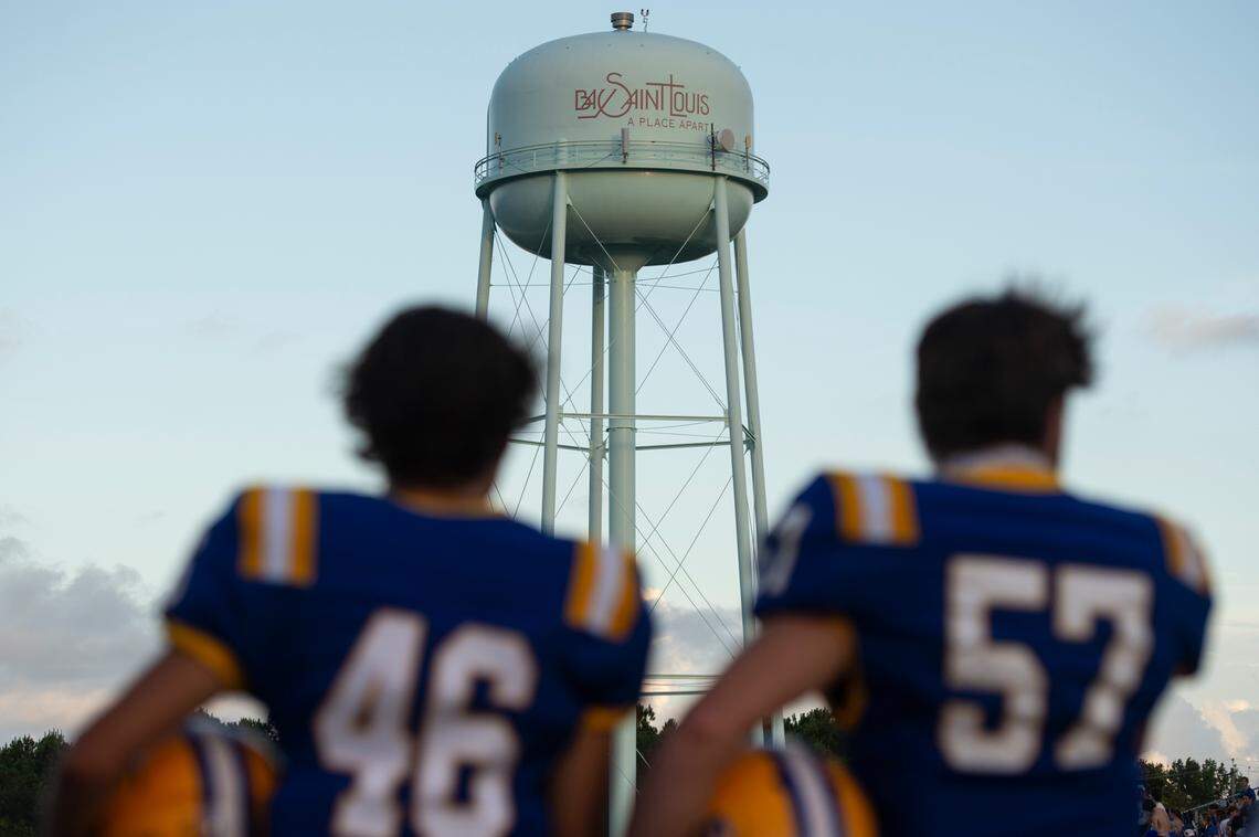Bay High football players stand for the pledge of allegiance before a game against St. Stanislaus at Bay High in Bay St. Louis on Friday, Sept. 1, 2023.