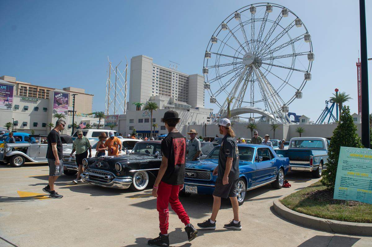 Spectators admire classic cars outside Paradise Pier at Margaritaville Resort Biloxi during Cruisin’ the Coast on Tuesday, Oct. 3, 2023.
