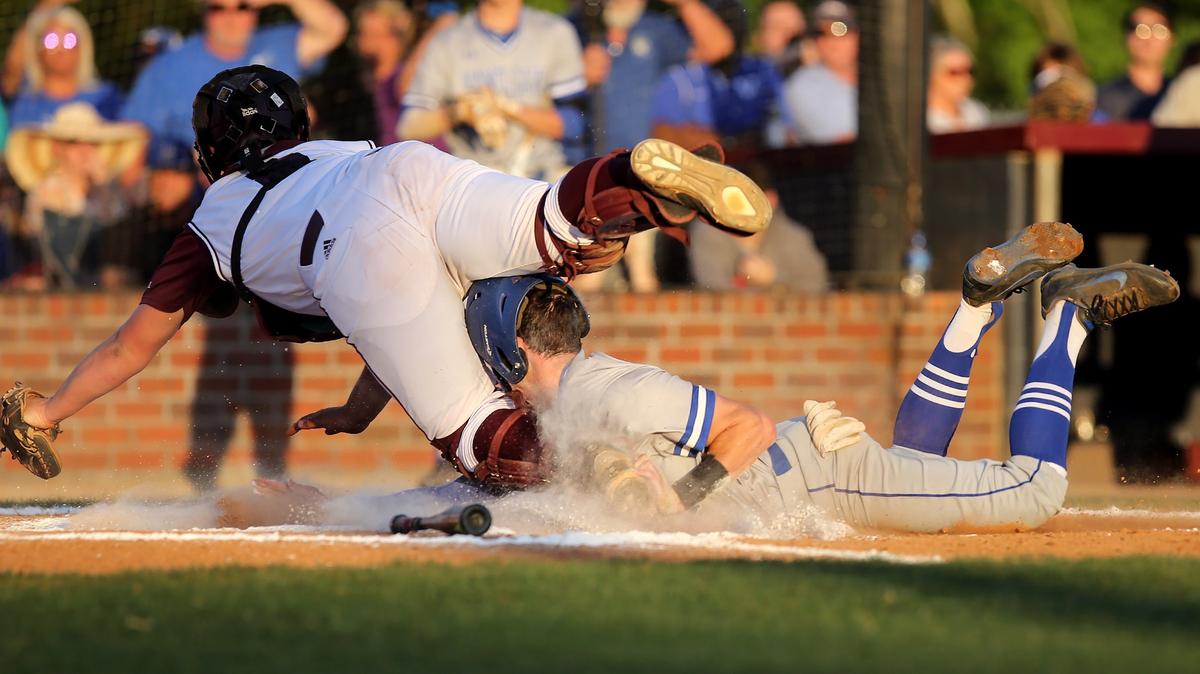 Vancleave's Colton Hipp collides with East Central catcher Louis Morgan while sliding into home plate during the first inning of Game 2 of the Class 4A South State series on Friday, May 11, 2018, at East Central.