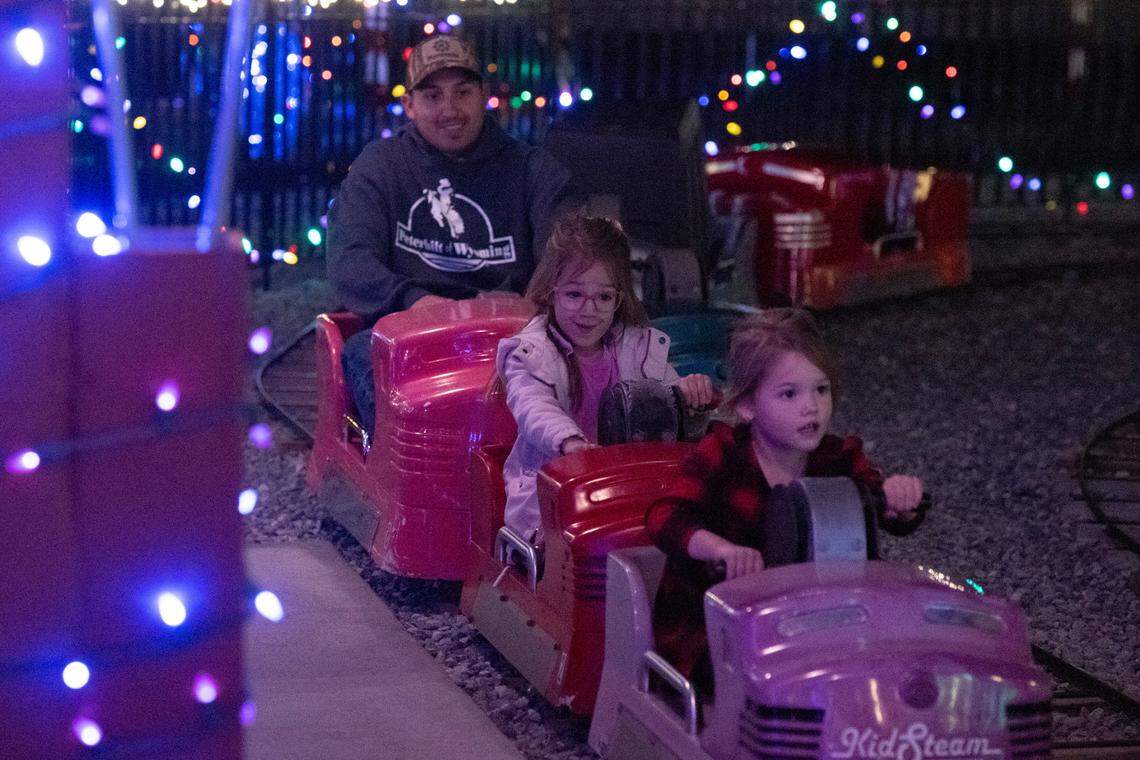 Families ride pedal train cars during a preview night for TrainTastic’s Holiday Lights event at TrainTastic Interactive Model Railroad Museum in Gulfport on Wednesday, Dec. 4, 2024.