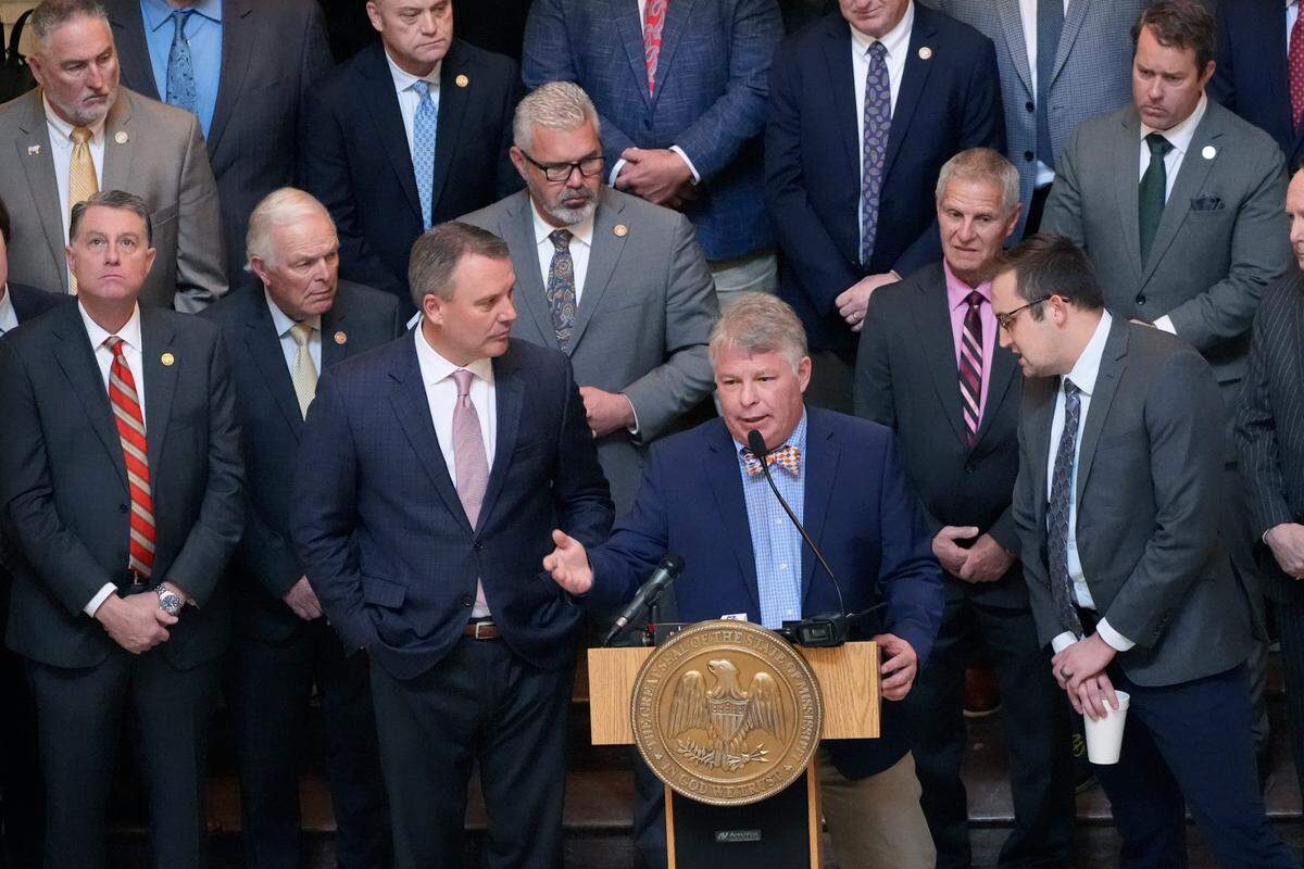 Flanked by members of the Mississippi House of Representatives and Speaker of the House Jason White, R-West, left, Mississippi House Education Committee Chairman Rep. Rob Roberson, R-Starkville, at podium, speaks to reporters about the body’s Wednesday’s passage of a new formula to calculate how much money the state will spend on public schools.
