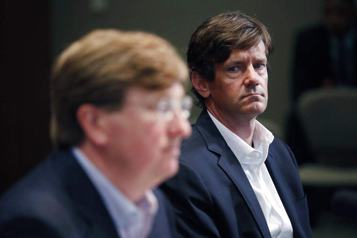 State Health Officer Dr. Thomas Dobbs, right, listens during a daily news briefing in May as Gov. Tate Reeves loosens a number of social and business restrictions from previous executive orders dealing with the early days of COVID-19.