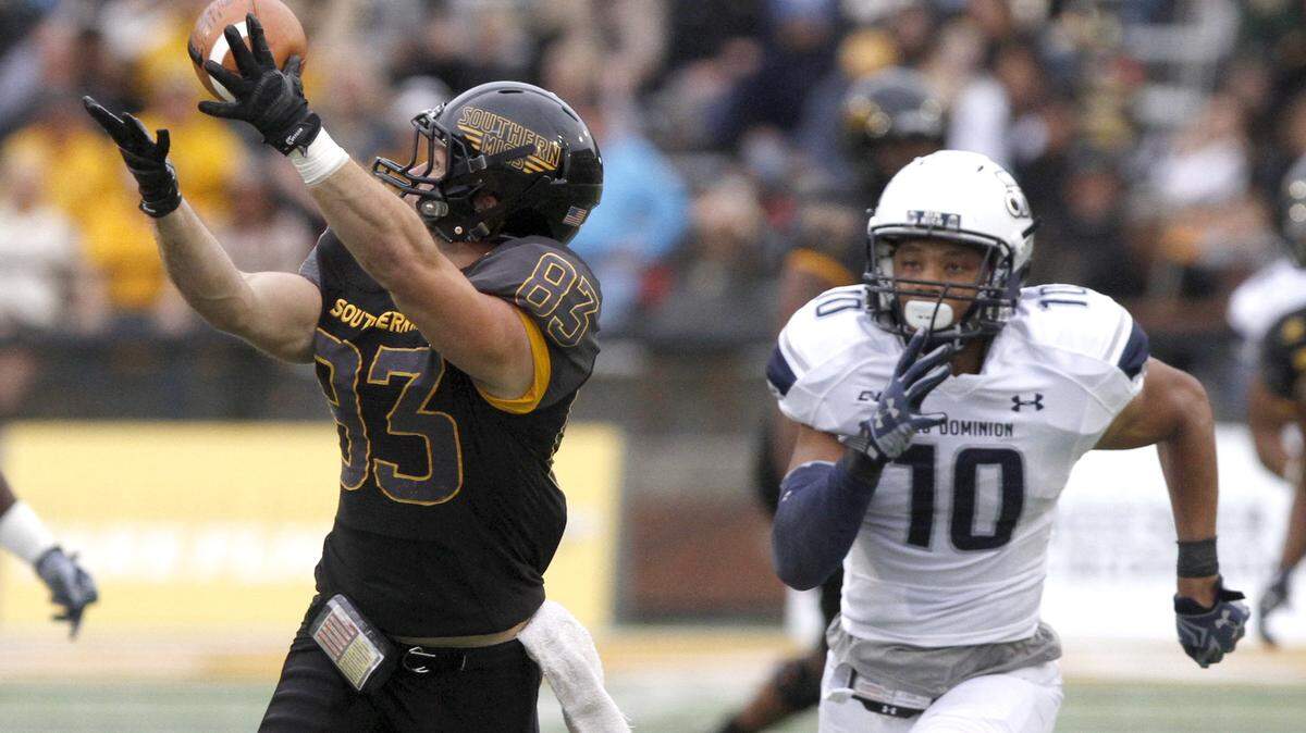 TIM ISBELL/SUN HERALD 
 Southern Miss receiver Casey Martin snags a Nick Mullens pass over Old Dominion's Sean Carter on Nov. 21 in Hattiesburg.
