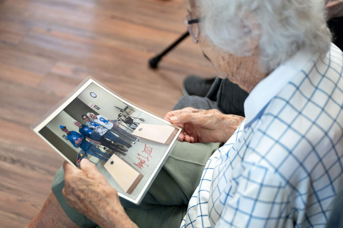 Helen Calehuff looks at a photo from last year’s cornhole contest at the Lyman Senior Center on Tuesday.