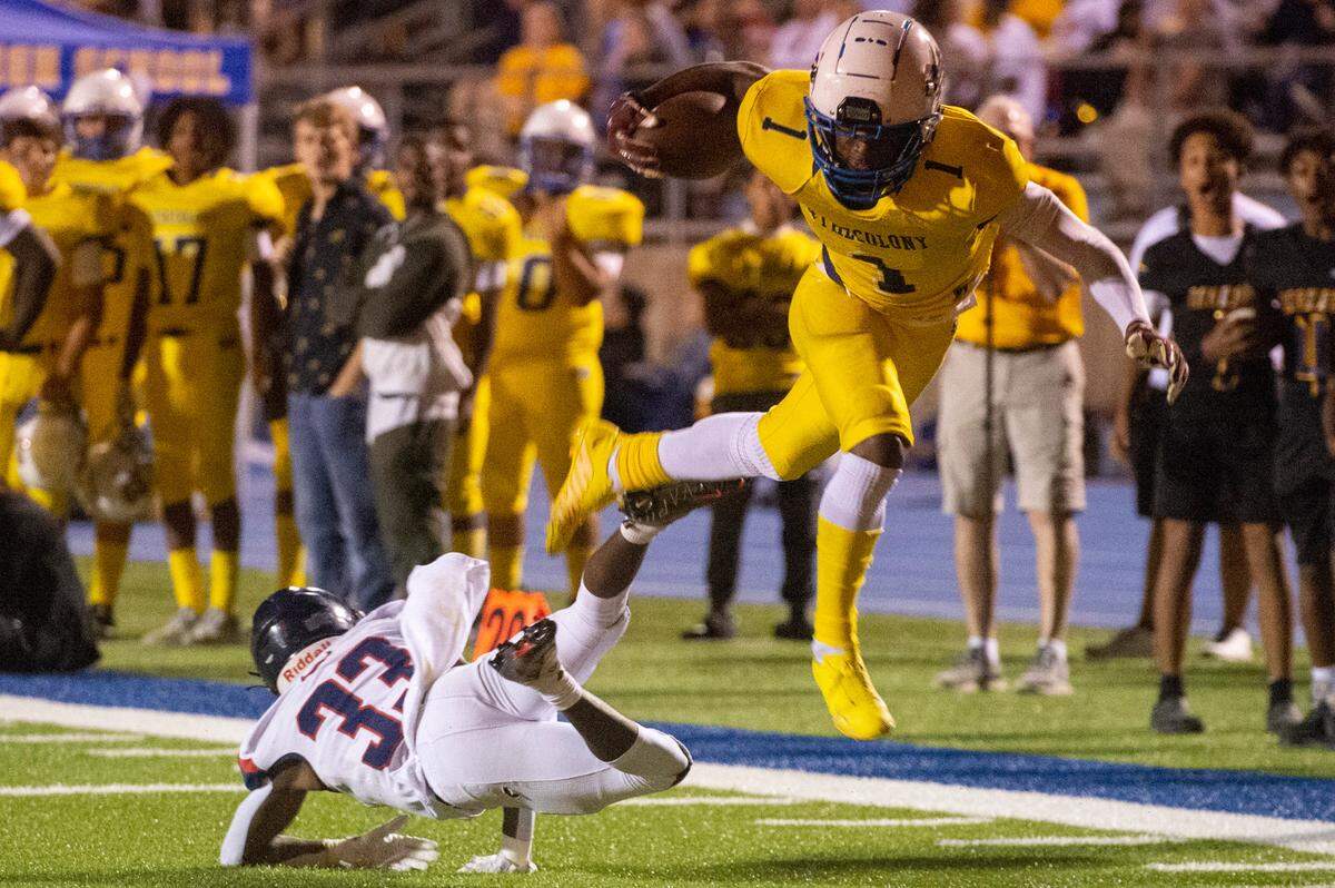 St. Martin’s Noreel White jumps over Hancock’s Destin Coleman as he runs the ball down the field during a game against Hancock at Joe Barlow Stadium in St. Martin on Friday, Sept. 30, 2022.