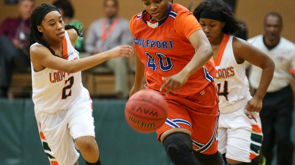 AMANDA McCOY/SUN HERALDGulfport's Jatiah Lathan sprints down the court with West Harrison's Deseree Moore, left, and Gerriana Williams behind her on Tuesday, December 15, 2015, at West Harrison High.