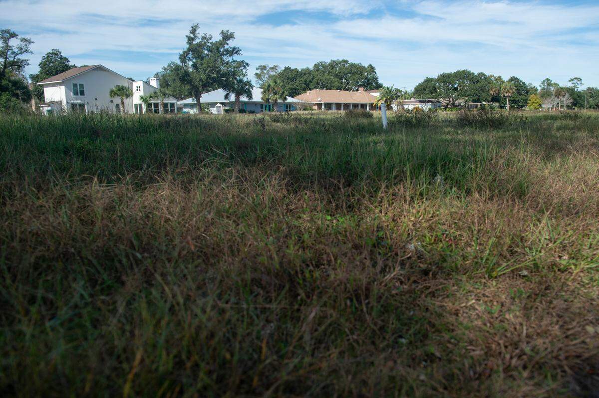 Grass and weeds have grown up on what used to be fairways of Great Southern Golf Club on Wednesday, Nov. 9, 2022. The club, which closed in May, is supposed to be developed into housing developments but neighbors are concerned about the environmental impact.